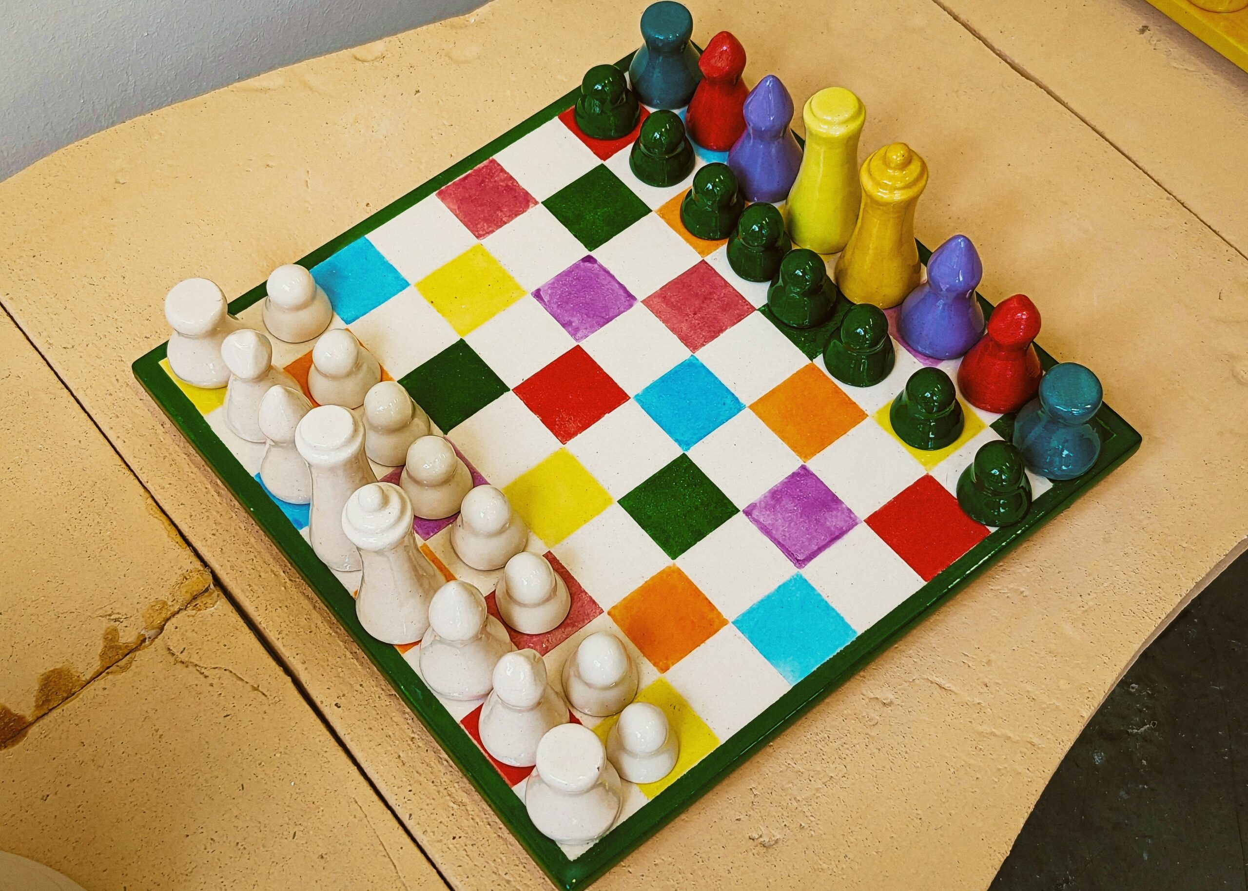 A set of brightly colored child-safe nail clippers arranged on a white surface.