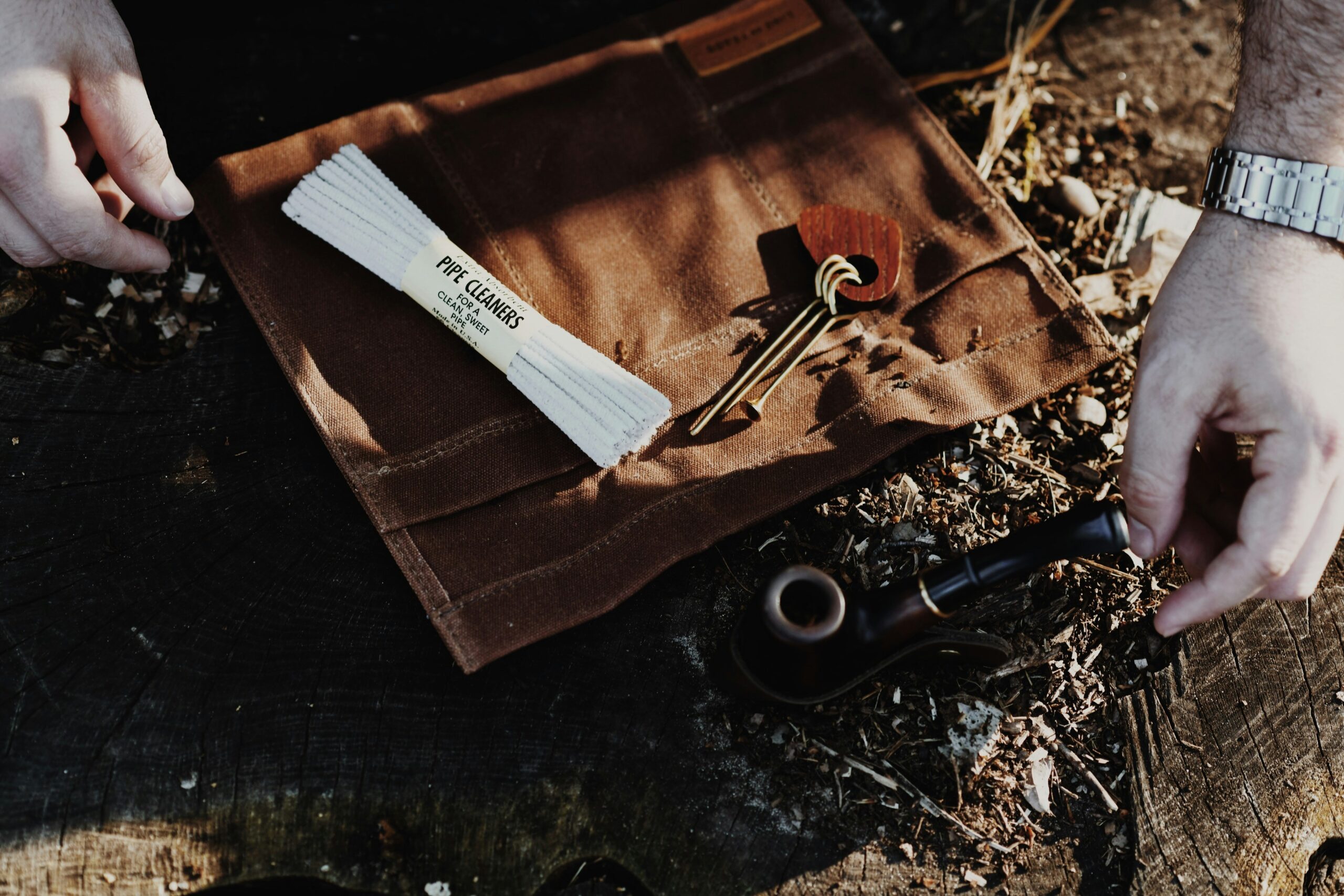 Detailed photo of Tweezerman Pro Suede Nail Clipper laid next to a velvet bag
