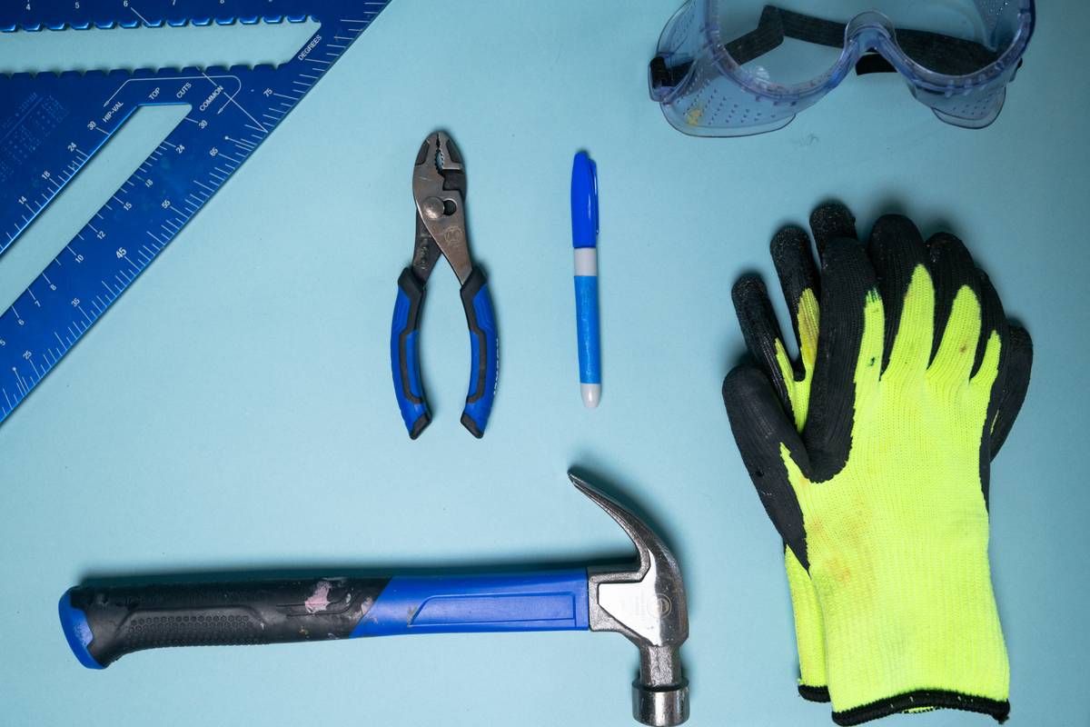 An artistic setup featuring professional clippers alongside nail polish bottles and brushes