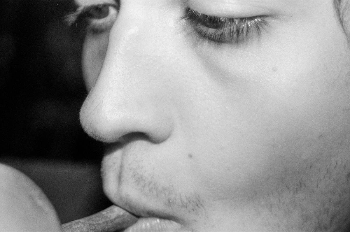 A close-up image of an athlete trimming their fingernails with high-quality stainless steel nail clippers.