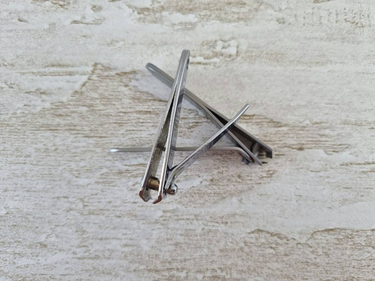 a pair of scissors sitting on top of a wooden table