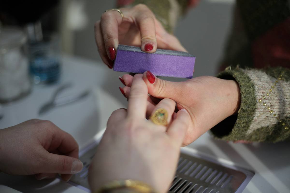 a woman is putting a ring on another woman's finger