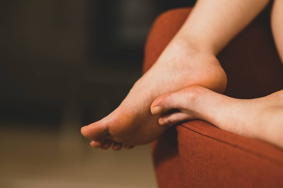 feet of a woman sitting on the sofa