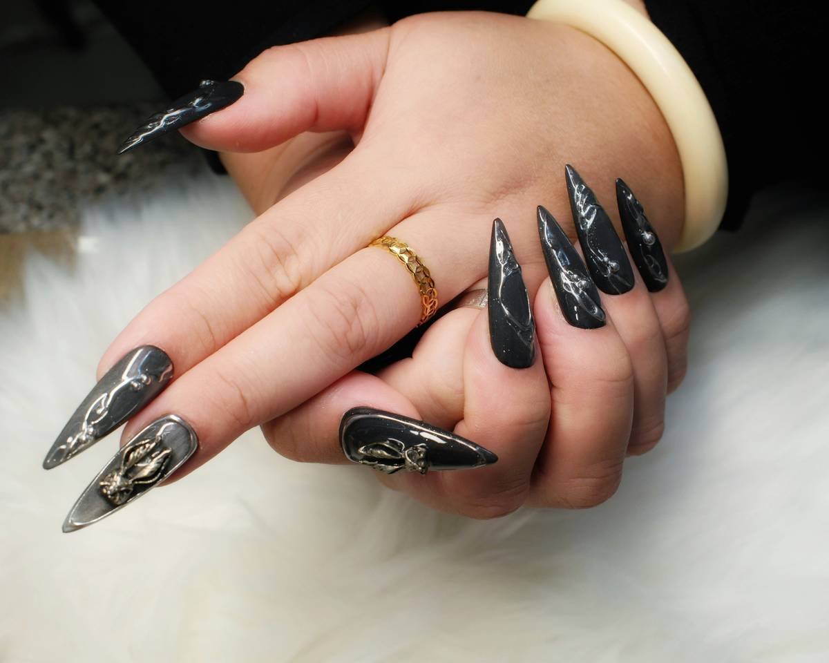 Woman's hand with long black stiletto nails