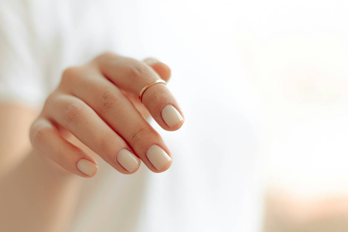 Close-up of properly sanitized stainless steel nail clippers on a clean white cloth as part of a nail care hygiene guide