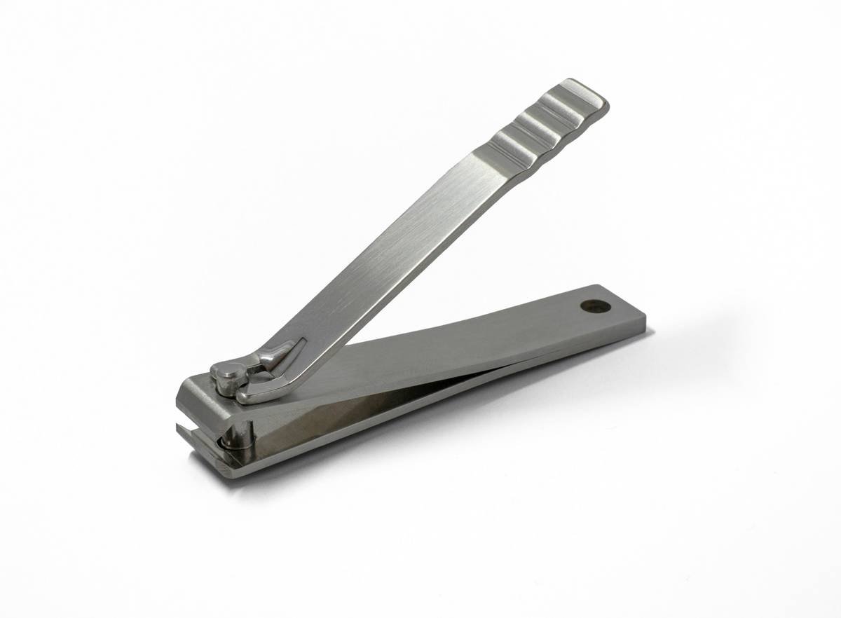 disassembled nail clipper parts laid out on clean towel for nail clipper cleaning guide